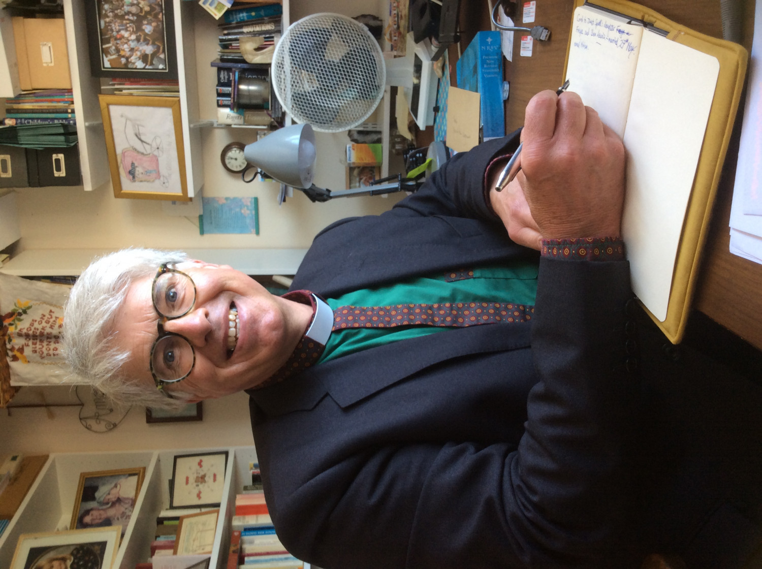 an image of Reverend Stephen Skinner at his desk smiling